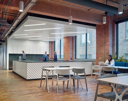 Press kit | 1513-01 - Press release | Slack Toronto Office - Dubbeldam Architecture + Design - Commercial Interior Design -  Inspired by Scandinavian design, the millwork in the café features diagonal painted wood slats in Baltic birch, reinforcing linearity throughout the open spaces.<br>  - Photo credit: Shai Gil