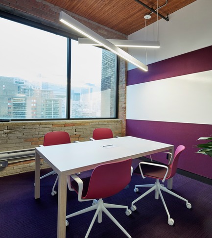 Press kit | 1513-01 - Press release | Slack Toronto Office - Dubbeldam Architecture + Design - Commercial Interior Design -  Meeting rooms are each coordinated around a different, bold colour. This room features a dark magenta carried through the Stylex chairs,Interface carpet, and Designtex acoustic wallcovering, which is offset by the whiteboard, Actiu meeting table edged in birch, and angled white light fixtures by Lumenwerx.<br>  - Photo credit: Shai Gil