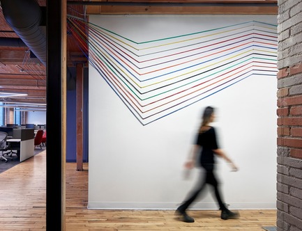 Press kit | 1513-01 - Press release | Slack Toronto Office - Dubbeldam Architecture + Design - Commercial Interior Design -  Colourful networking cables that once again reinforce Slack’s brand colours are threaded throughout the workspaces, along the ceiling and across walls, as visual accents.<br>  - Photo credit: Shai Gil