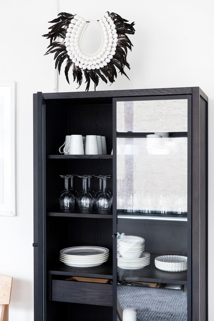 Press kit | 1122-05 - Press release | Purchasing a Kitchen Online is Now Child’s Play with coquo.ca - Coquo by Cuisines Steam - Product -   A close-up of coquo's Volitare armoire with glass doors shown in midnight black stained oak in the Witness Apartment kitchen.    - Photo credit:  Jessica Nash 