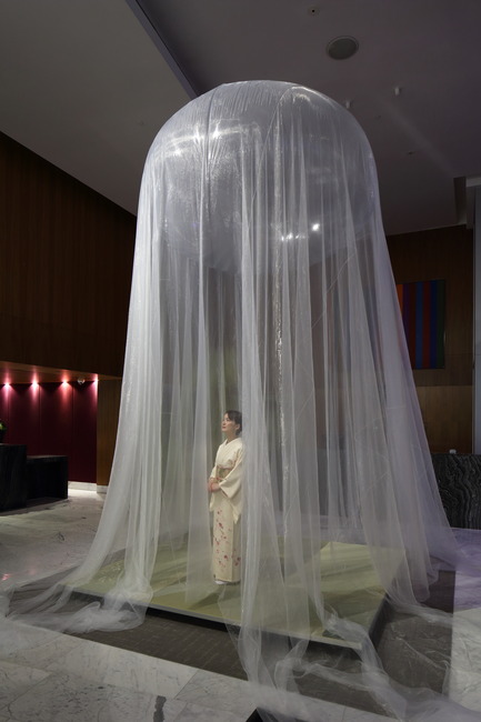 Press kit | 2051-04 - Press release | Japan Unlayered Officially Opens - Westbank | Peterson - Event + Exhibition -         Floating Teahouse in the entrance lobby of Fairmont Pacific Rim - the traditional Japanese teahouse is given contemporary treatment with a 130 square metre 'Super Organza' fabric roof, made of 27 micron polyester (one sixth the thickness of a strand of hair), suspended from a translucent helium balloon - Photo credit: Ema Peter