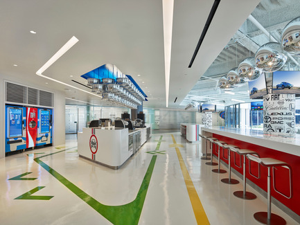 Press kit | 2222-01 - Press release | EdQuarters - M+M Creative Studio - Commercial Interior Design - Main coffee bar leading to the conferencing area beyond (notice chrome wheels in ceiling above coffee prep area), with adjacent vending machines (one distributes 'Matchbox' cars)  - Photo credit: Benny Chan @Fotoworks 