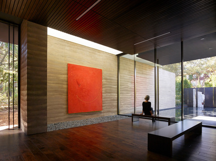 Press kit | 2112-02 - Press release | Windhover Contemplative Center selected as Architizer A+ Finalist - Aidlin Darling Design - Institutional Architecture -         <br> Nathan Oliveira’s “Big Red” greets visitors upon entering the building. The rammed earth wall extends from the entry to the reflecting pool beyond, blurring the line between interior and exterior. - Photo credit: Matthew Millman