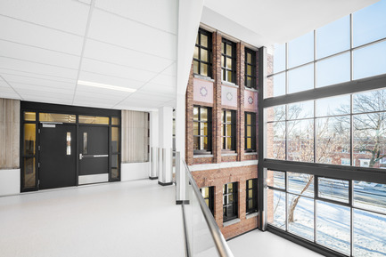 Press kit | 752-03 - Press release | Bronze tightrope walker… welcomes Park Extension schoolchildren - NFOE et associés architectes - Institutional Architecture - Full-height glazed atrium highlights one of the older brick facades - Photo credit: Charles Lanteigne