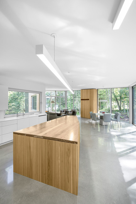 Press kit | 780-03 - Press release | House on Lac Grenier - Paul Bernier Architecte - Residential Architecture -         Kitchen island and view toward living area       - Photo credit: Adrien Williams