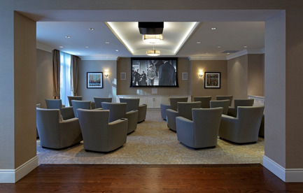 Press kit | 1855-01 - Press release | Newcombe Design Group’s approach to retirement living honoured with ARIDO Award - Newcombe Design Associates - Commercial Interior Design - The Media Room's firm, upright lounge seating with drink holders makes for easy, comfortable film watching. Durable upholstery fabrics are used throughout the common areas for durability and ease of maintenance. - Photo credit: David Whittaker