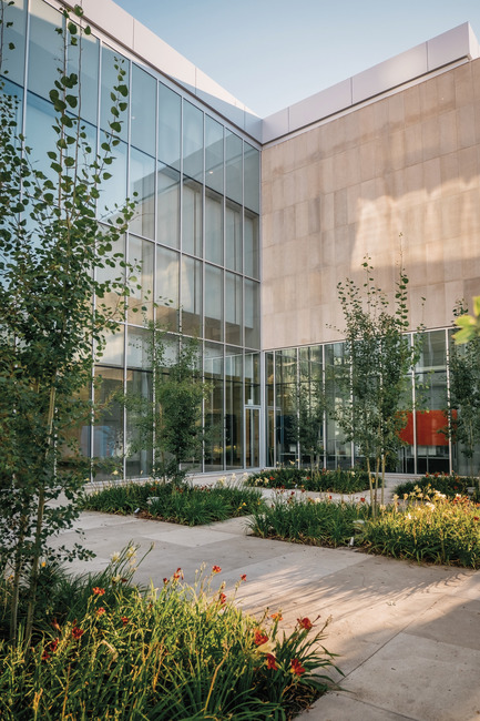 Press kit | 2073-09 - Press release | Discover the new Royal Alberta Museum - DIALOG - Institutional Architecture - The Fraser Courtyard brings to life the old 98 Street that was previously lost to downtown Edmonton development. Aspen trees are planted here, forming a high canopy to accommodate cafe seating underneath. Day Lilies are planted below the Aspen trees—a breed developed by researchers in Alberta before rising to popularity around North America. - Photo credit: Tom Arban Photography Inc