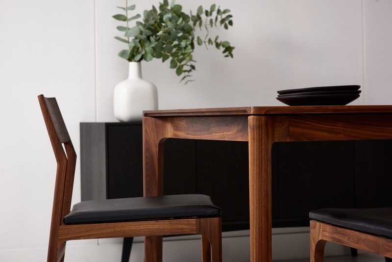 Press kit | 1077-07 - Press release | Creative form meets functionality with the Cove Collection by Kastella - Kastella - Product - T113 table & C205 chairs shown in American Black Walnut - Photo credit: Adam Stein